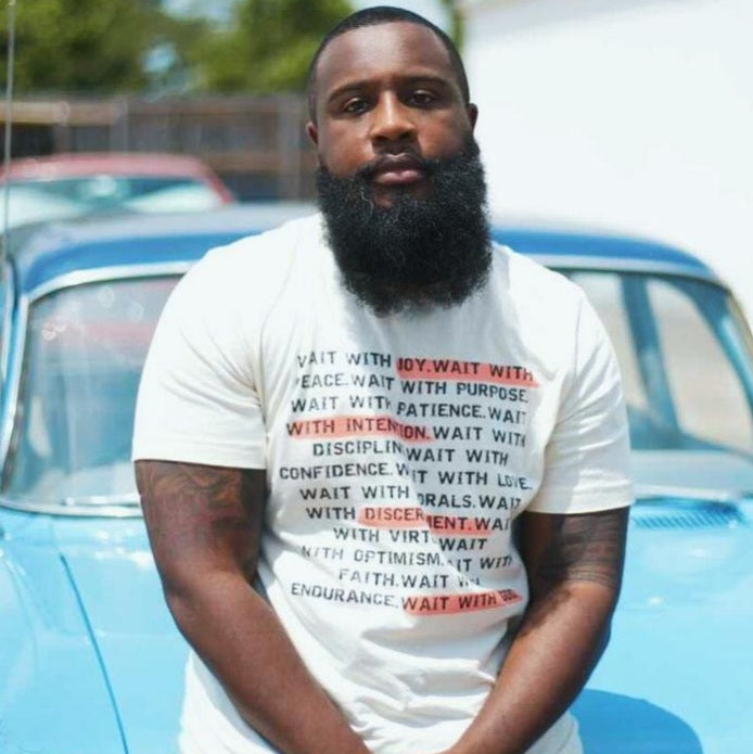 Black man wearing a wait t-shirt