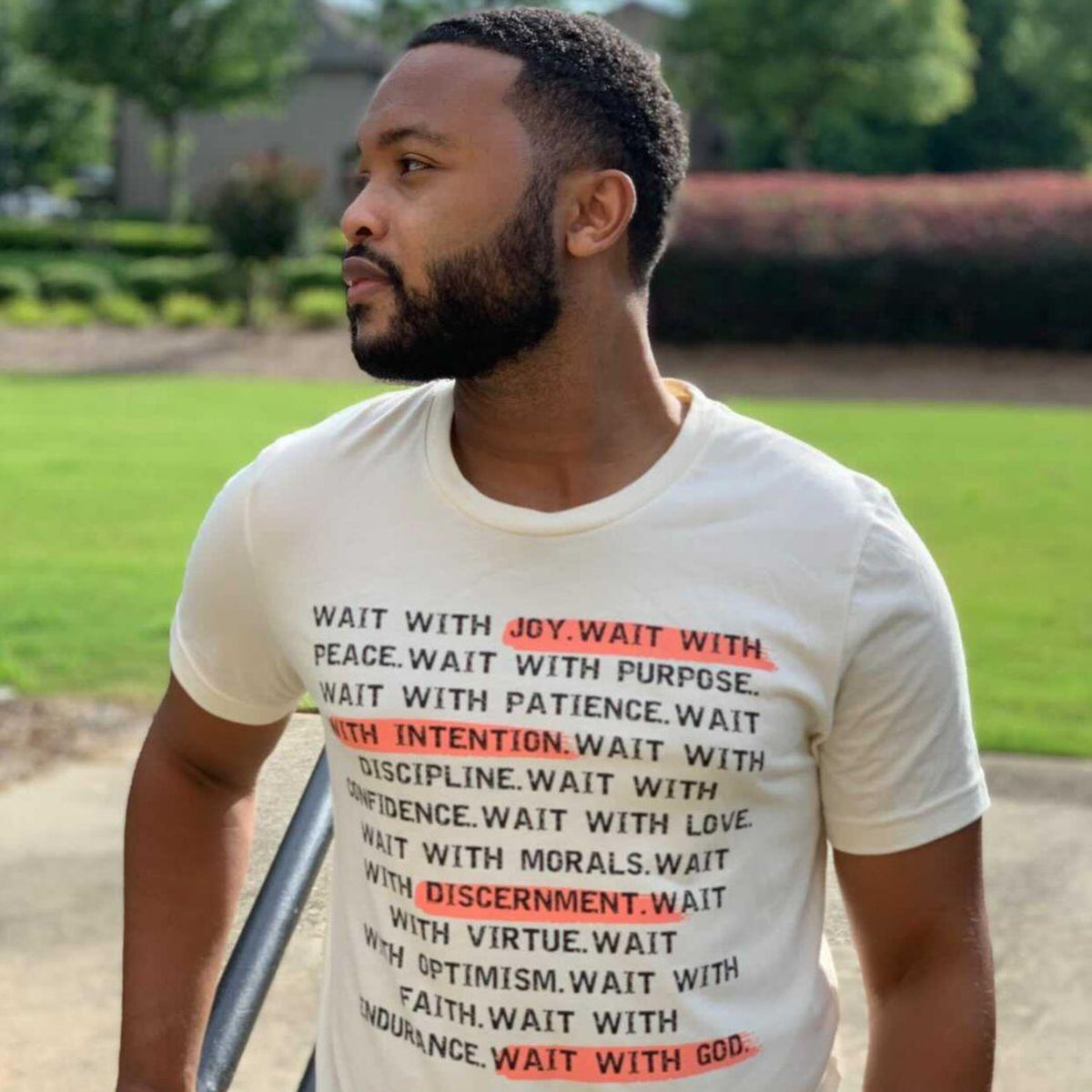 Black man wearing a wait t-shirt