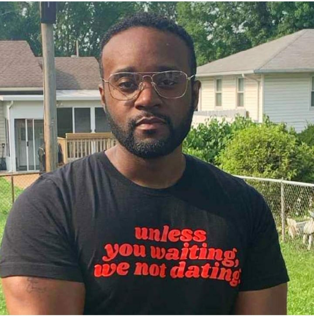 Black man wearing Unless you waiting we not dating black unisex t-shirt