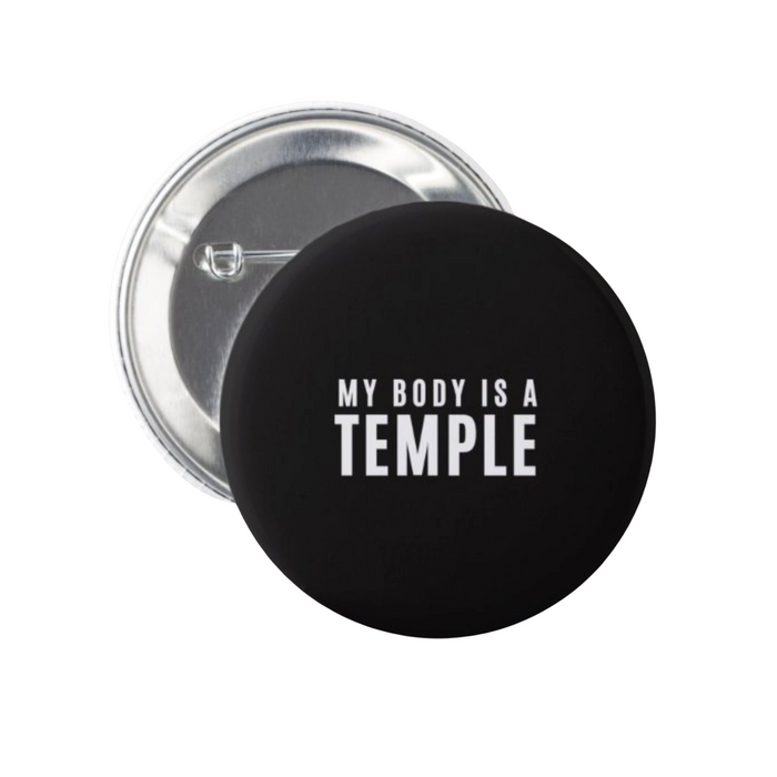 Black My Body Is A Temple Christian button with white lettering showing the metal pin-back closure