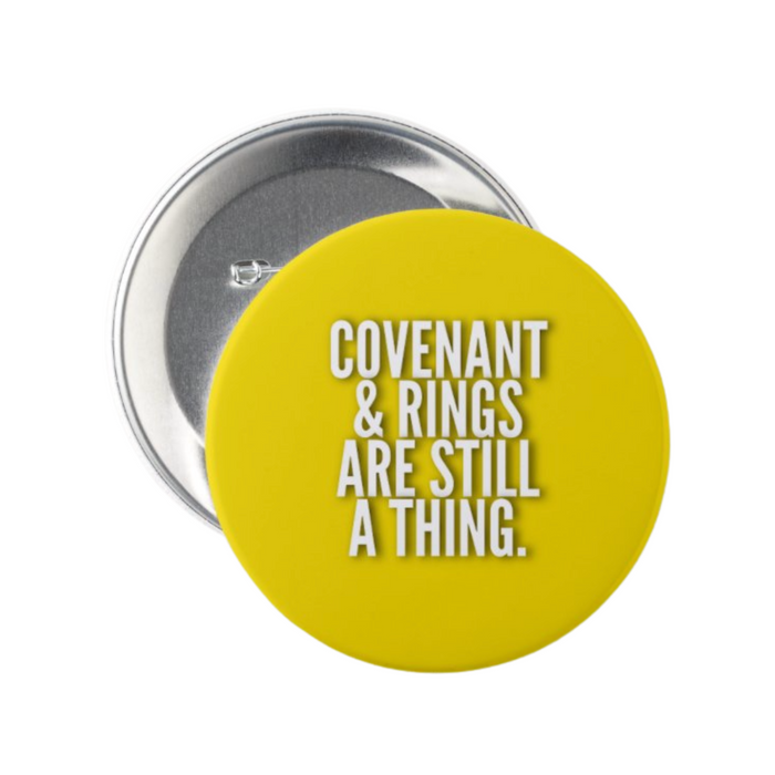 Yellow “Covenant & Rings Are Still A Thing” Christian marriage button showing the metal pin-back closure